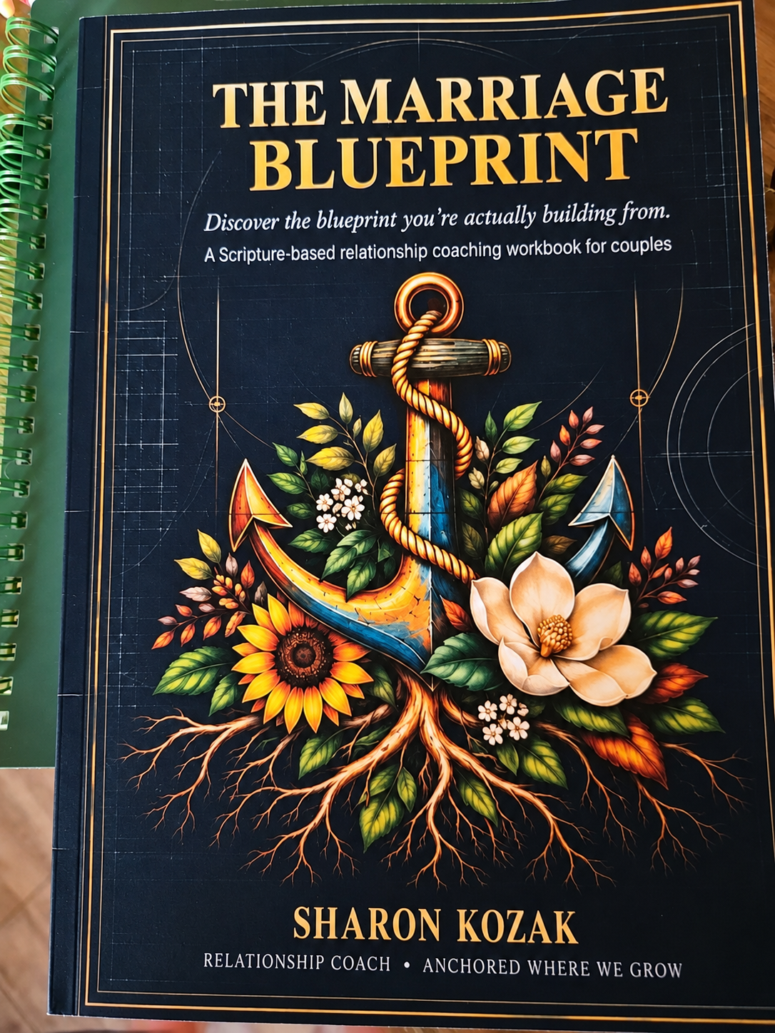 Photograph of the original cover of The Marriage Blueprint by Sharon Kozak, featuring an anchor, sunflower, magnolia, and roots on a navy background